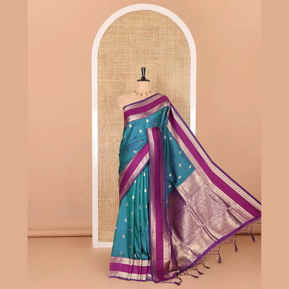 Pothys Blue zari buttas kanchi soft silk saree, contrast manga and peacock motifs woven rettai pettu border, ogee patterned pallu, and a zari design blouse
