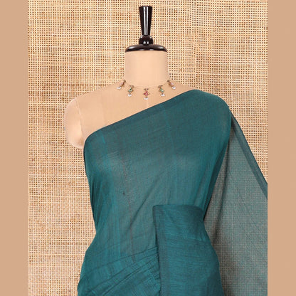 Pothys Borderless Peacock Color Plain Khadi Mul Cotton Saree Features a Self-Pallu with Tassels, and a Matching Blouse
