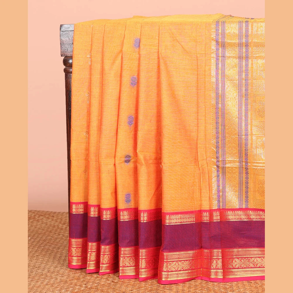Pothys Orange Chettinad Cotton Saree Adorned with Floral Thread Buttas All Over Its Body, Complemented by Contrast Rettai Pettu Border of Traditional Designs, Pallu of Peacock and Yaali Butta Enclosed Checks, and Paired with a Matching Blouse