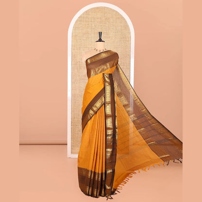 Pothys Mustard Plain Chettinad Cotton Saree, Complemented by Contrast Rettai Pettu Traditional Zari Temple Border of Peacocks, Subtly Striped Pallu, and Paired with a Matching Blouse