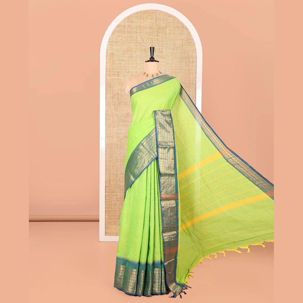 Pothys Parrot Green Plain Chettinad Cotton Saree, Complemented by Contrast Border Steeped with Traditional Zari Designs, Subtly Striped Pallu, and Paired with a Matching Blouse