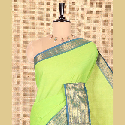 Pothys Parrot Green Plain Chettinad Cotton Saree, Complemented by Contrast Border Steeped with Traditional Zari Designs, Subtly Striped Pallu, and Paired with a Matching Blouse