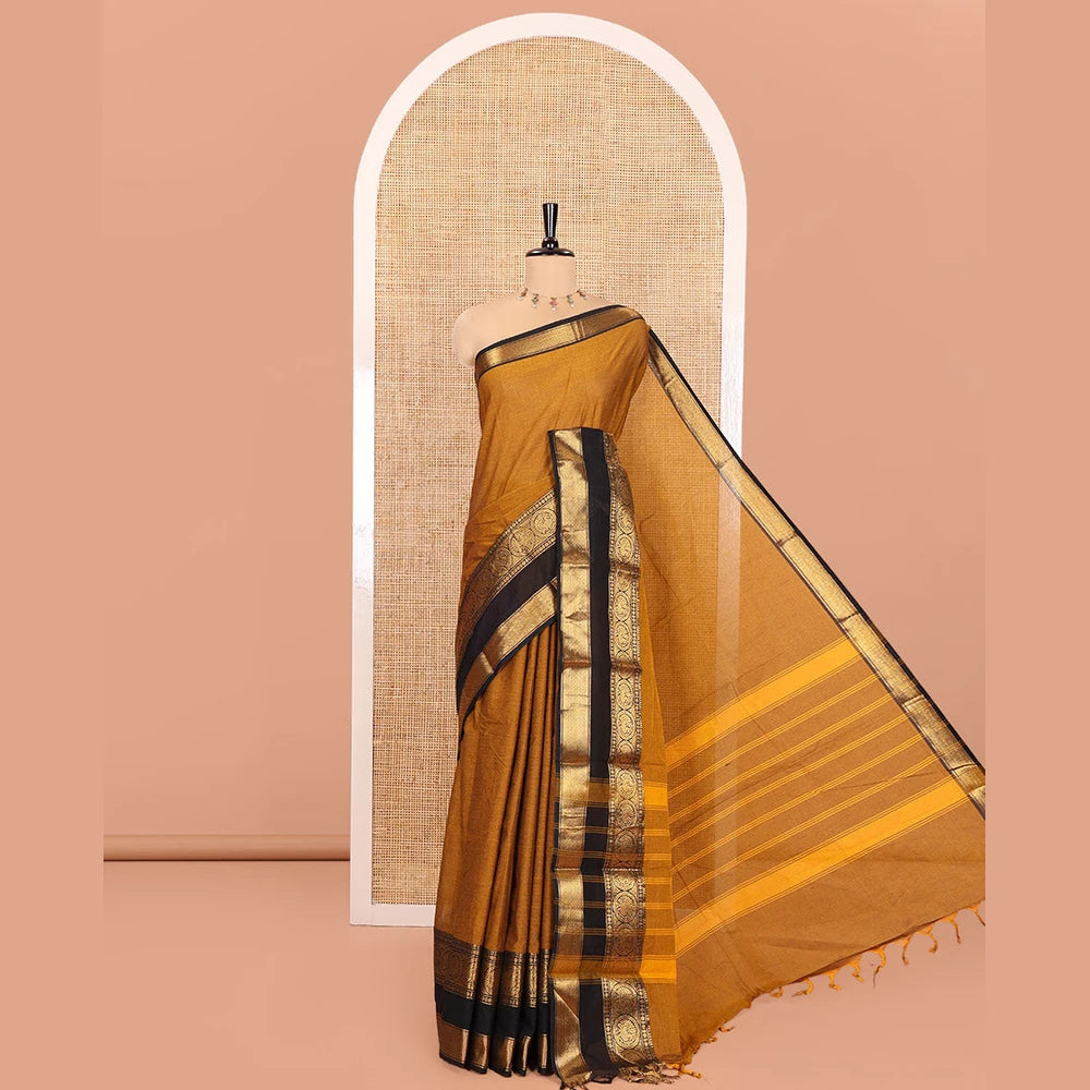 Pothys Gold Plain Chettinad Cotton Saree, Complemented by a Contrast Rettai Pettu Traditional Border of Round Peacock Designs, Striped Pallu, and Paired with a Matching Blouse