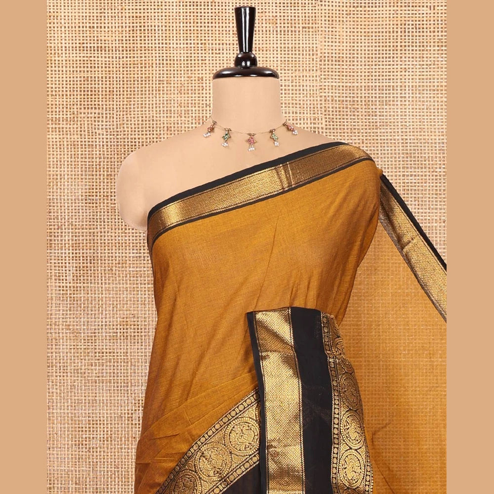 Pothys Gold Plain Chettinad Cotton Saree, Complemented by a Contrast Rettai Pettu Traditional Border of Round Peacock Designs, Striped Pallu, and Paired with a Matching Blouse