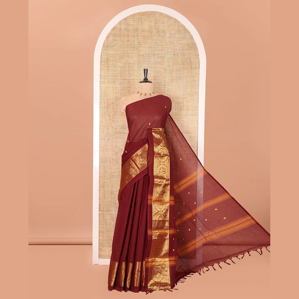 Pothys Coffee Brown Chettinad Cotton Saree, Subtly Sparkled with Buttas All Over Its Body, Highlighted Contrast by Zari Traditional Border of Round Chakram Designs, Pallu of Stripes and Buttas, and Paired with a Matching Blouse