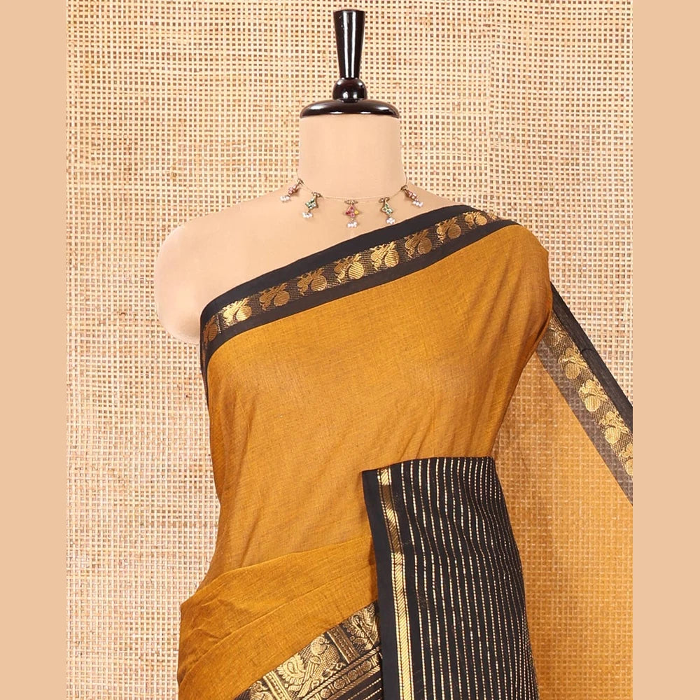Pothys Mustard Plain Chettinad Cotton Saree, Complemented by a Contrast Zari Traditional Border Steeped with Peacock Designs, Subtly Striped Pallu, and Paired with a Matching Blouse