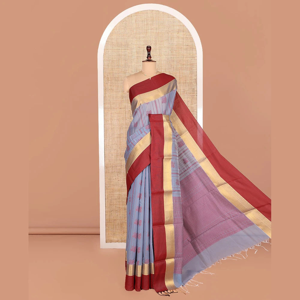 Pothys Grey Semi-Silk Cotton Saree, Sparsely Threaded with Buttas and Stripes All Over Its Body, Complemented by a Contrast Border of Traditional Zari Designs, Pallu of Jaal Designs, and Paired with a Matching Blouse