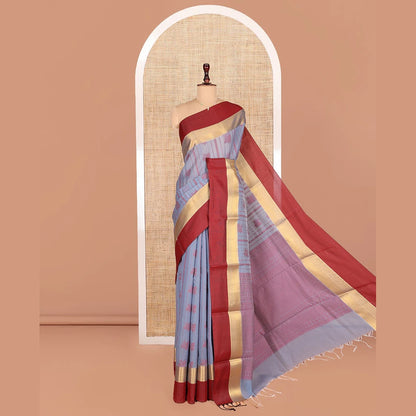 Pothys Grey Semi-Silk Cotton Saree, Sparsely Threaded with Buttas and Stripes All Over Its Body, Complemented by a Contrast Border of Traditional Zari Designs, Pallu of Jaal Designs, and Paired with a Matching Blouse