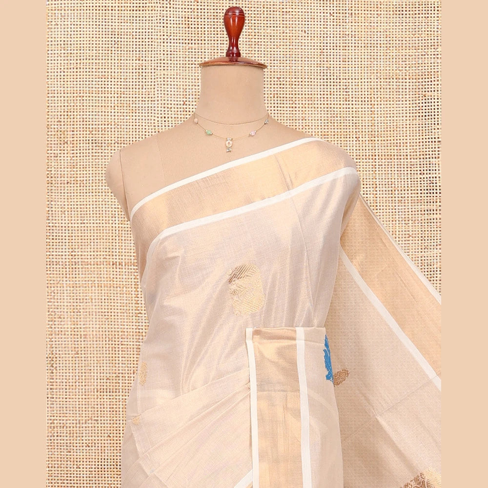 Pothys Cream Kerala Cotton Saree, Bedecked with Thread and Zari Buttas All Over Its Body, a Zari Bavanji Border, Pallu of Intricate Designs, and Paired with a Matching Blouse