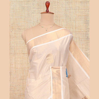 Pothys Cream Kerala Cotton Saree, Bedecked with Thread and Zari Buttas All Over Its Body, a Zari Bavanji Border, Pallu of Intricate Designs, and Paired with a Matching Blouse