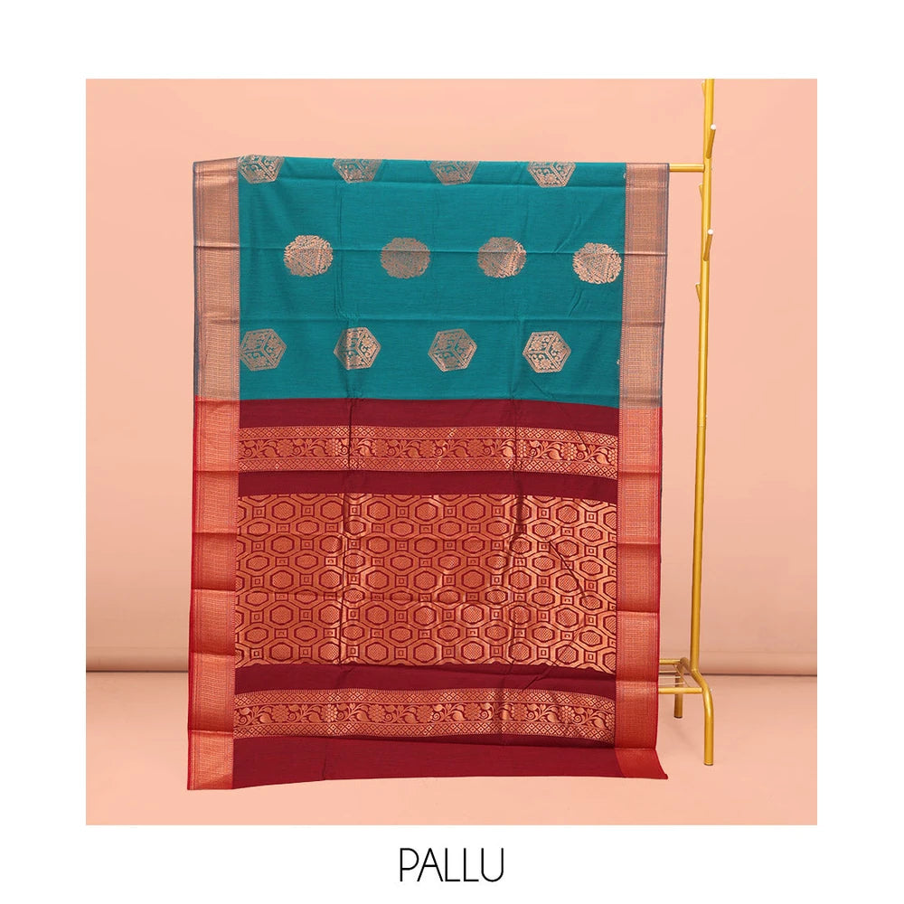 Pothys Rama Blue Semi-Silk Cotton Saree, Spotlighted with Zari Buttas All Over Its Body, Highlighted by a Traditional Zari Border, Pallu of Paisley Designs, and Paired with a Matching Blouse