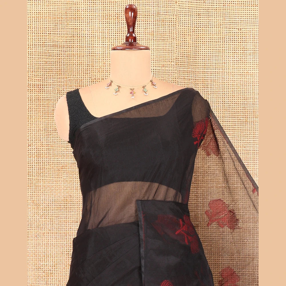 Pothys Borderless Black Semi-Silk Cotton Saree Features Floral Buttas, a Contrast Plain Pallu, and a Contrast Blouse