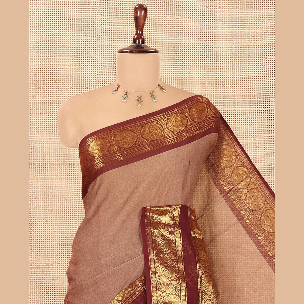 Pothys Brown Plain Chettinad Cotton Saree, Complemented by a Contrast Peacock-Chakram Rettai Pettu Border, and a Matching Blouse