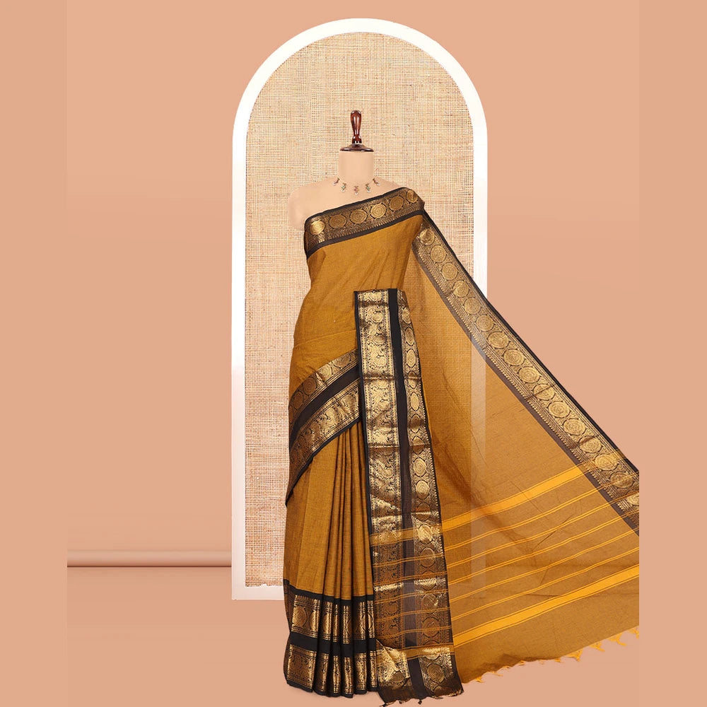 Pothys Mustard Plain Chettinad Cotton Saree, Complemented by a Contrast Peacock-Chakram Rettai Pettu Border, and a Matching Blouse